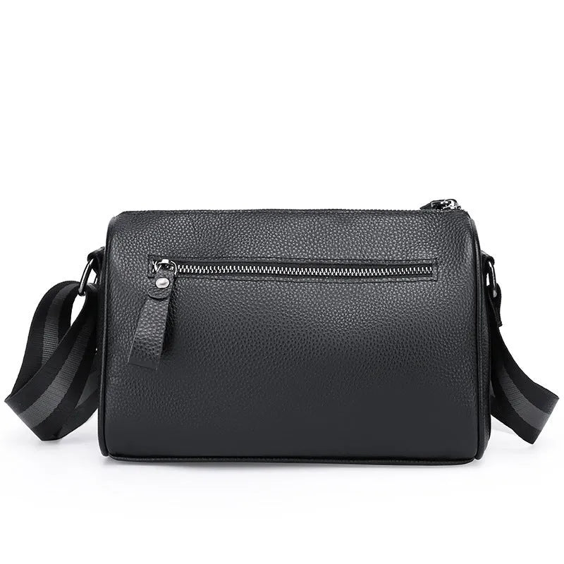 Black genuine leather crossbody bag with one-shoulder strap showing interior polyester lining