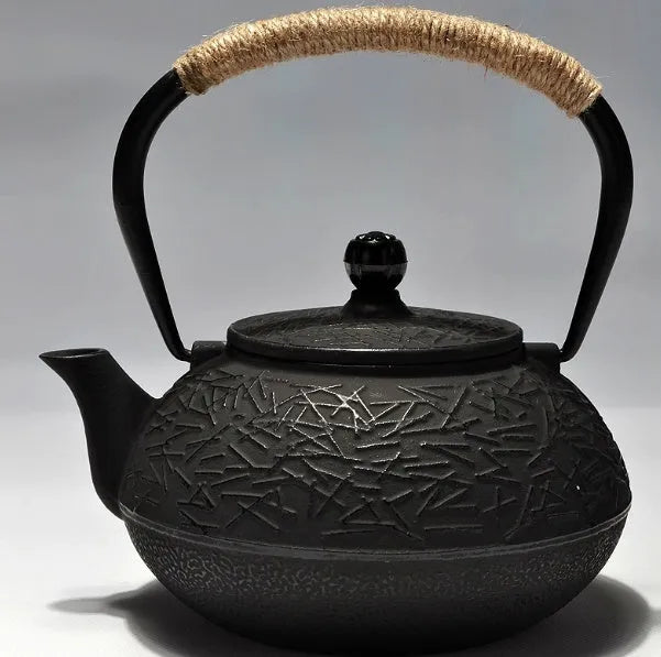 Japanese cast iron teapot in black with Peony pattern, showing lid, handle, and spout.