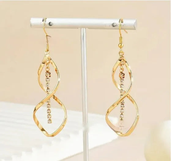 Gold colour geometric spiral design alloy earrings with elliptical elements for female wearers