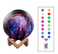 3D-printed spherical lunar night light with colour-changing LED illumination on a dark surface.