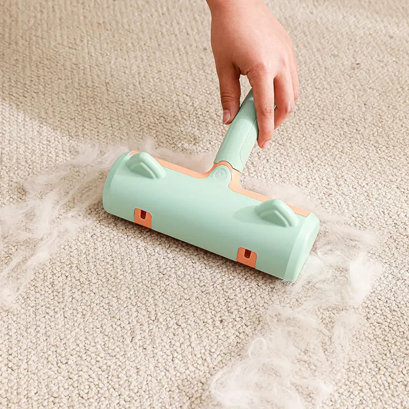 Mint green manual brush for removing cat hair from furniture and fabrics, showing its size.