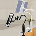 Black flexible tablet holder with bendy arm and suction base mounted on a desk