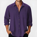A man's loose-fitting long sleeve beach shirt with a stand collar, shown in a solid colour.