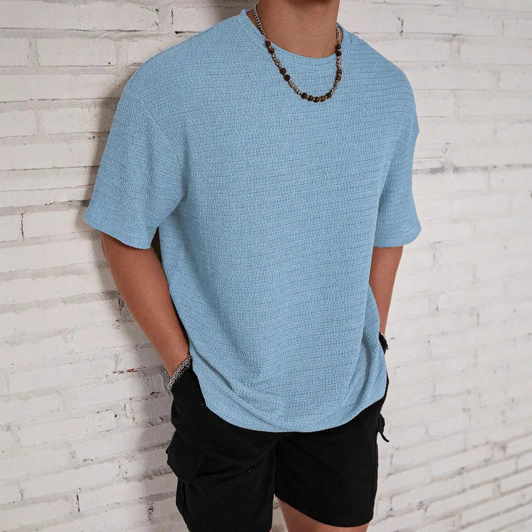 Men's slim fit solid colour T-shirt in light blue, showing round neck and short sleeves