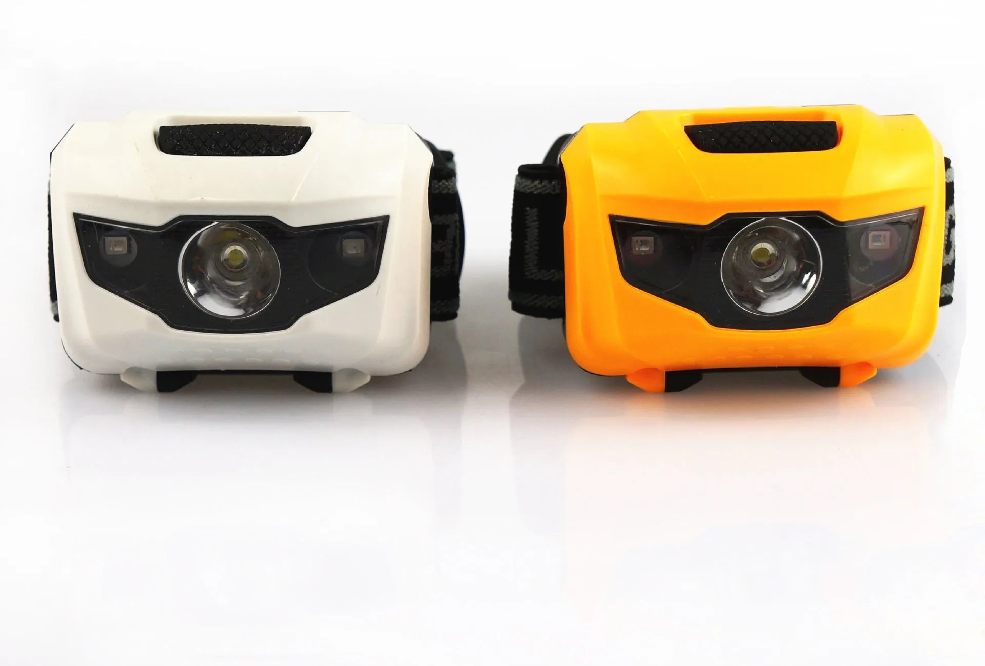 A black waterproof head torch with a central white LED and two smaller red LEDs, mounted on an adjustable headband.