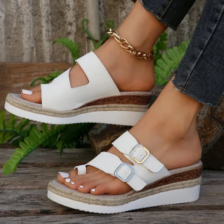 White patent leather wedge sandals with peep toe and woven finger fit straps