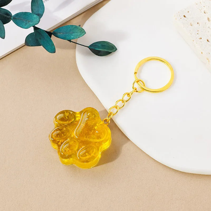 Small natural crystal cat's paw claw charm on a metal loop keychain