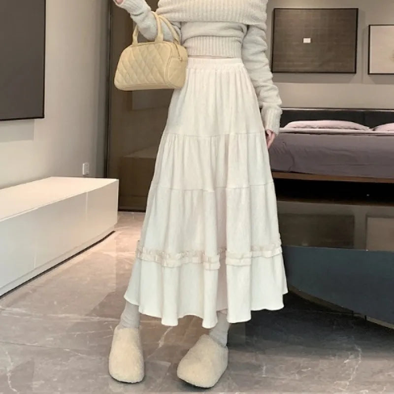 Women's corduroy A-line midi skirt with elastic waistband in milky white, black, and brown colours