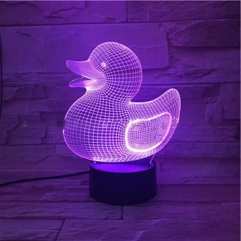 Yellow duck cartoon 3D night light table lamp with remote control on a table.