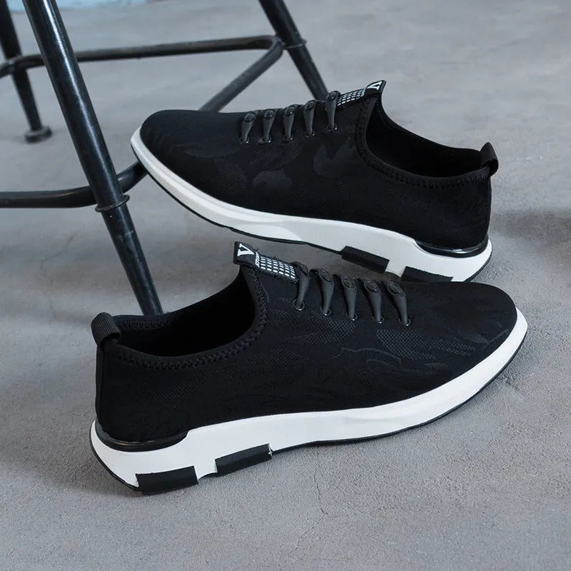 Men's black cloth upper sports casual shoes with rubber sole, low heel, and lace-up closure on a neutral background