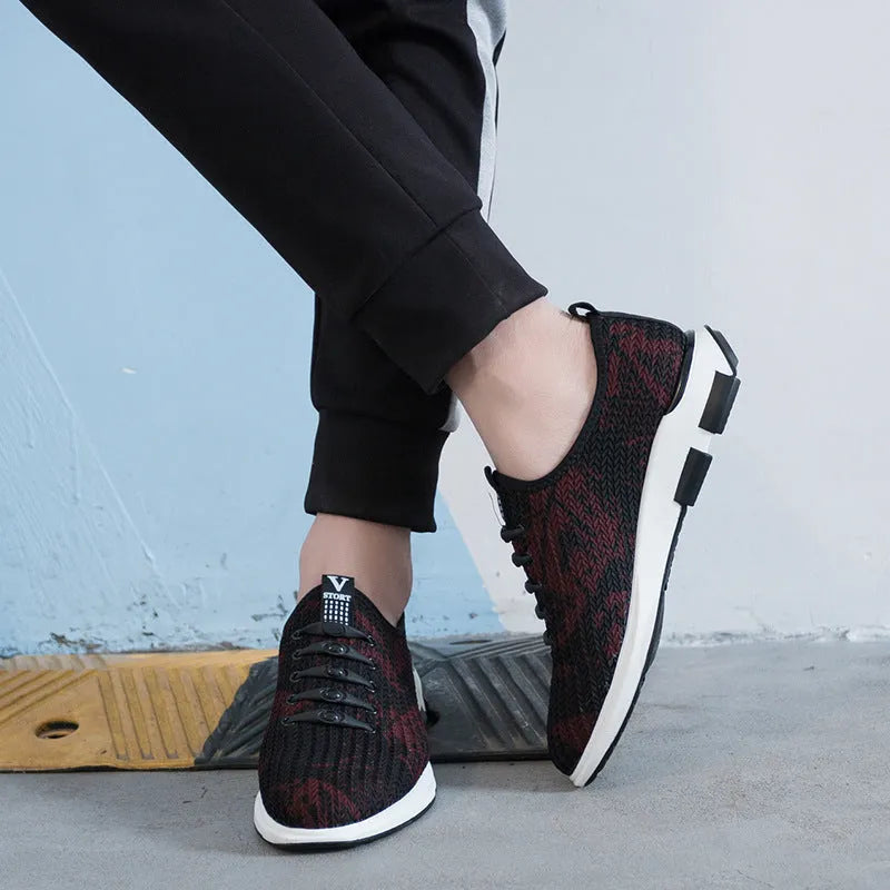 Men's black cloth upper sports casual shoes with rubber sole, low heel, and lace-up closure on a neutral background