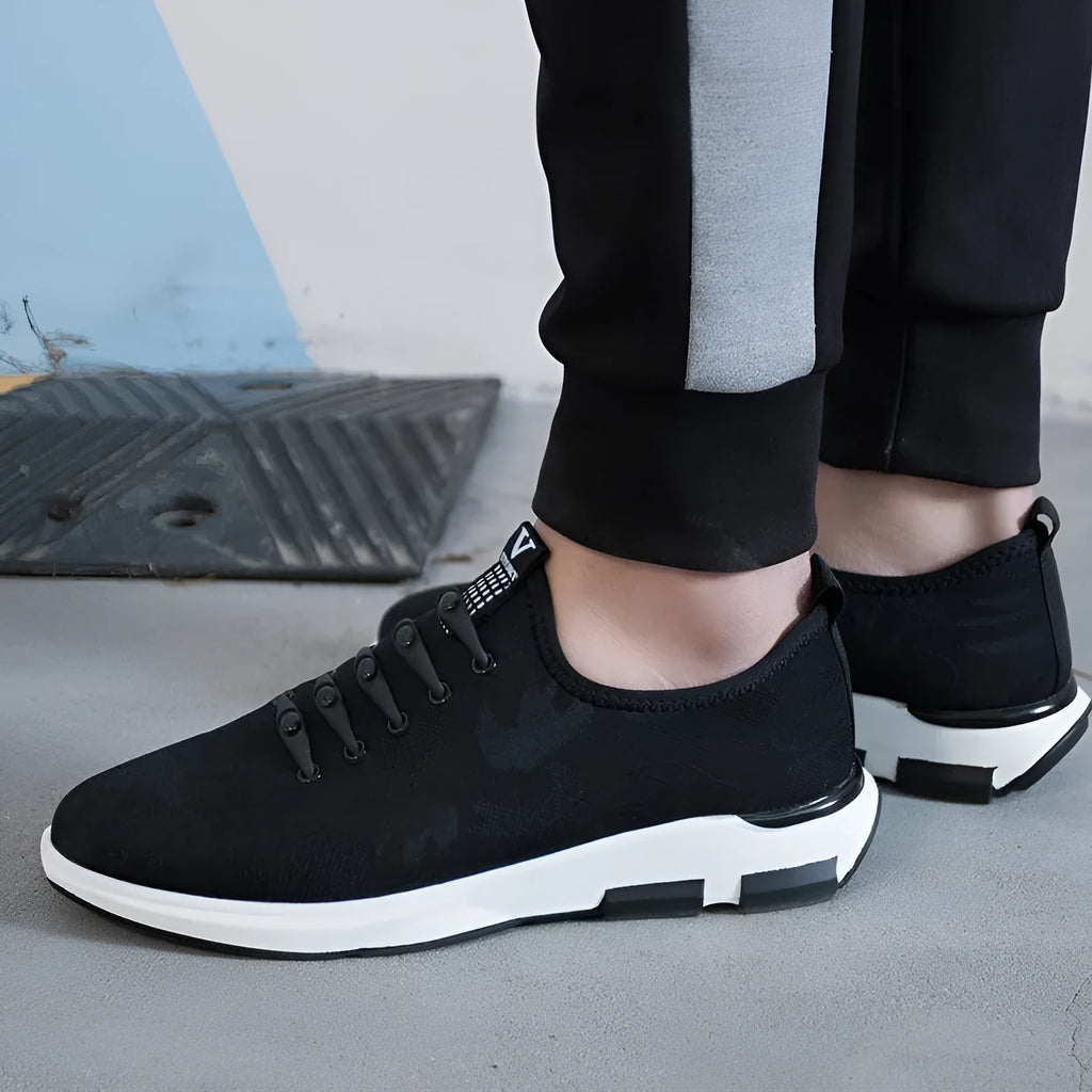 Men's black cloth upper sports casual shoes with rubber sole, low heel, and lace-up closure on a neutral background
