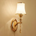 European style glass wall lamp with a fabric cable switch, shown in a bedroom setting.