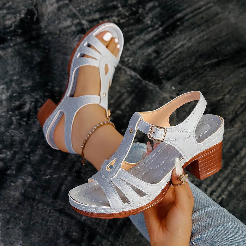 Women's black peep toe wedge sandals showing buckle fastening and fish mouth toe design