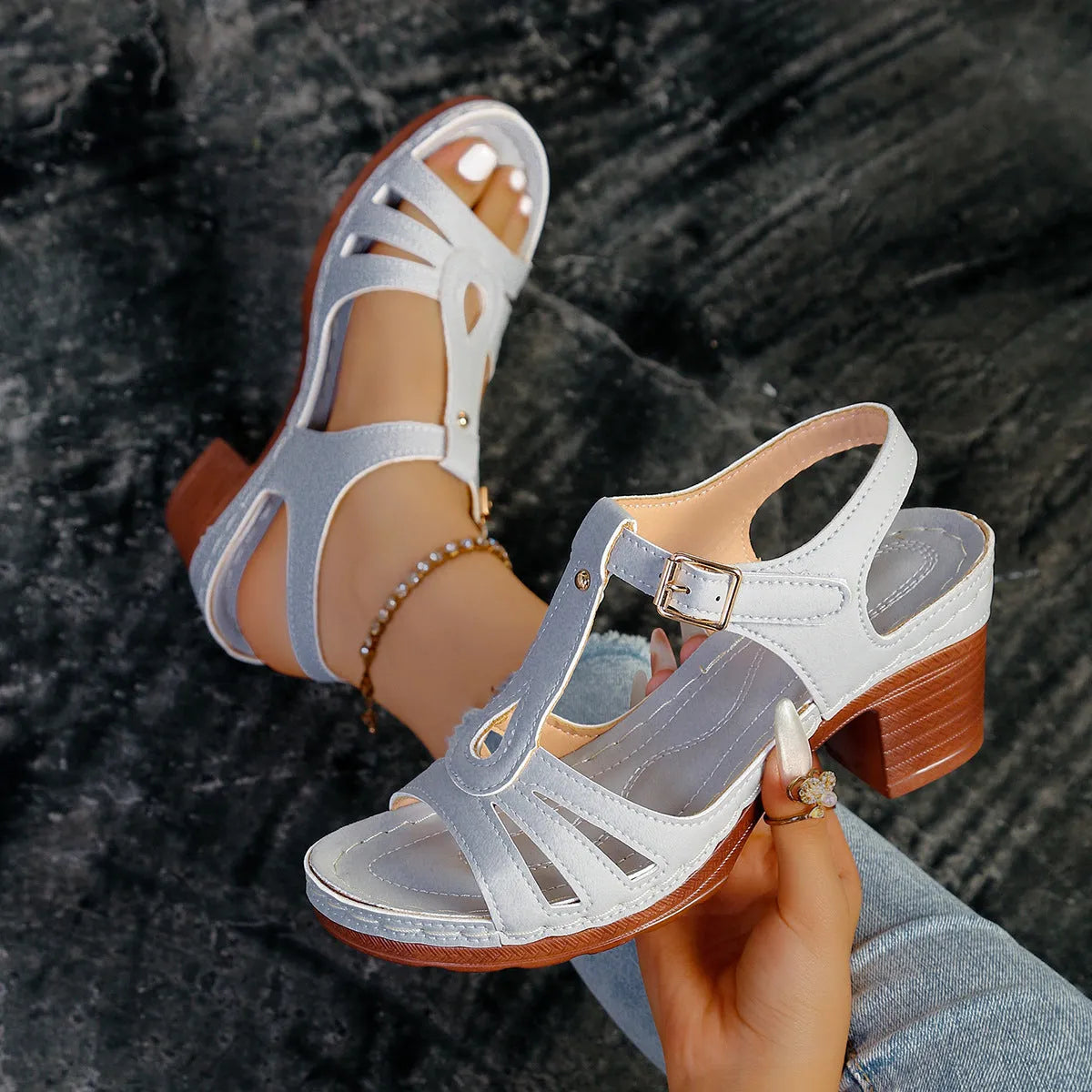 Women's black peep toe wedge sandals showing buckle fastening and fish mouth toe design