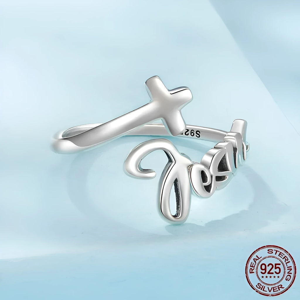 S925 sterling silver cross letter open ring with oxidised finish and adjustable opening on neutral background