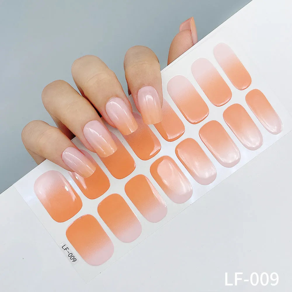 Full sheet of nail art stickers showing sixteen small designs including cross, rose, tulip, and leopard print patterns.