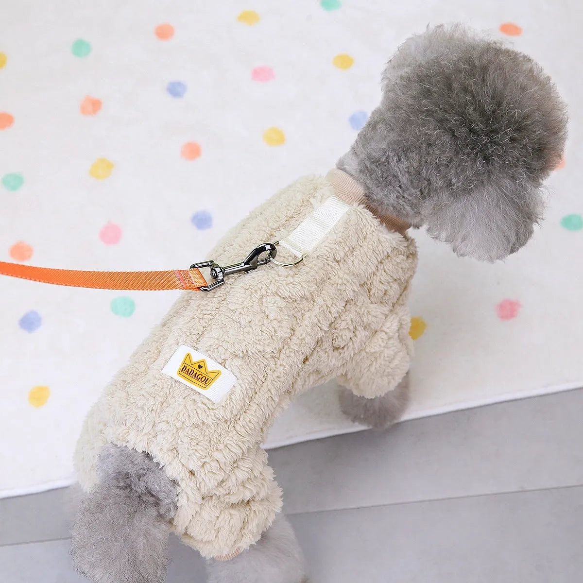 Four-legged dog fleece jacket in khaki on a small breed dog outdoors