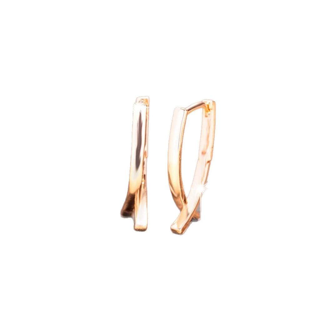 Rose gold plated cross-shaped drop earrings on a copper base.
