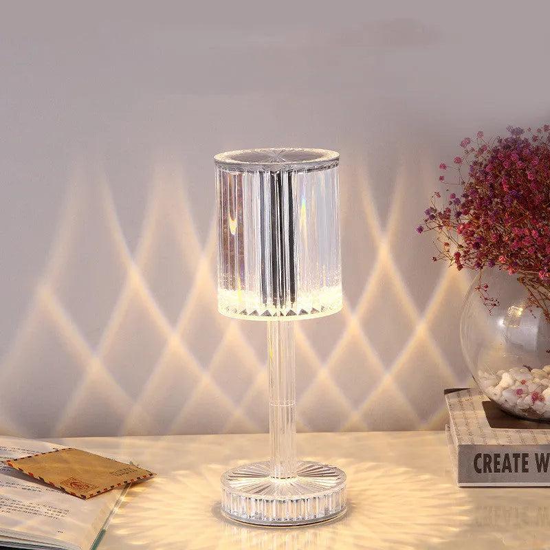 Amber K9 crystal table lamp with double-layered lampshade on a modern bedside table, warm LED light on medium brightness