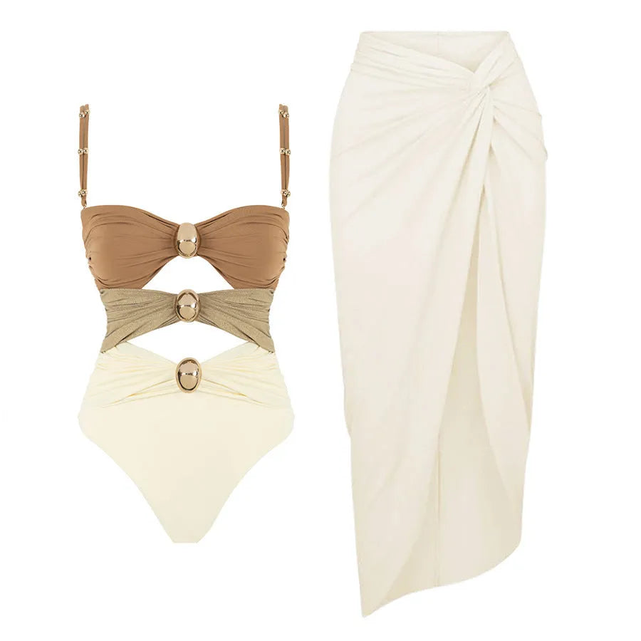 Women's solid colour one-piece swimsuit with gold buttons and a matching skirt.