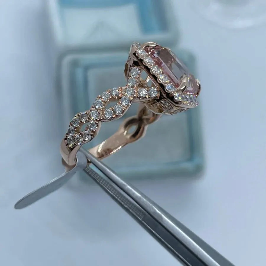 A geometric-shaped rose gold alloy ring on a plain background.