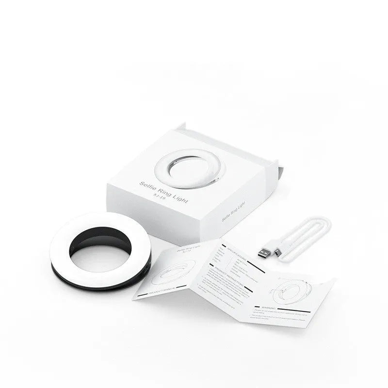Compact black LED selfie ring light with USB cable for mobile phone photography.