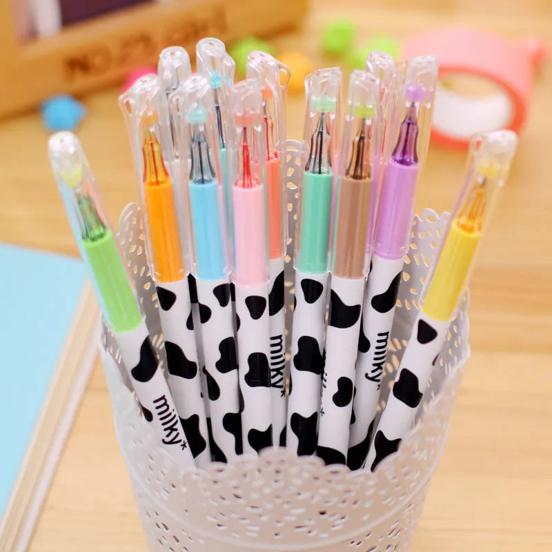 Box of 12 cow colour gel pens with 0.38mm fine tips on a desk.