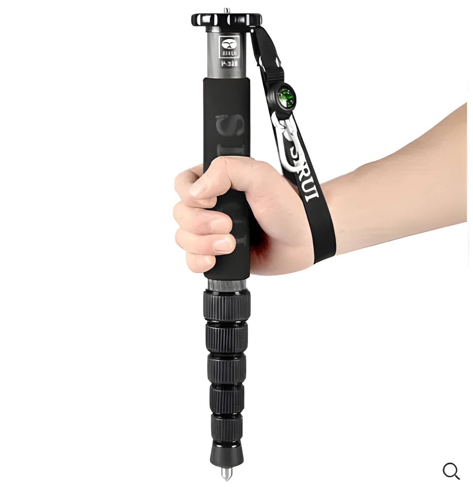 Black carbon fibre SLR camera monopod extended to maximum height with six visible sections