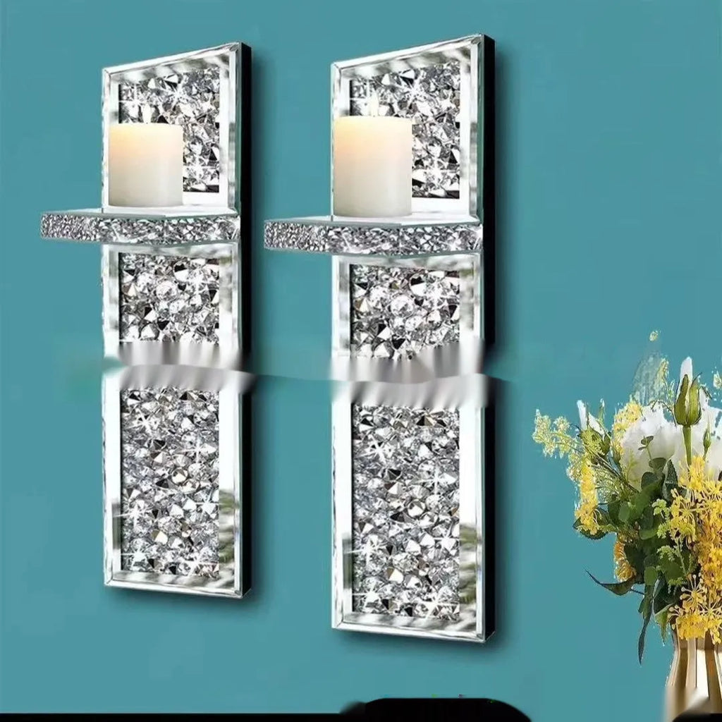 Pair of tall, silver mirror glass candlesticks designed for wall mounting in a living room.