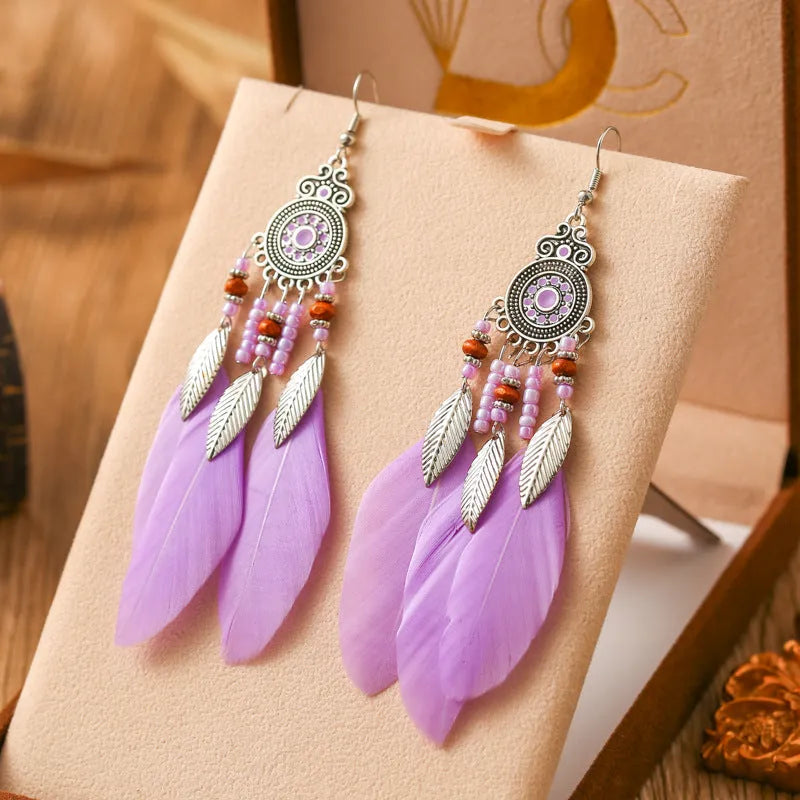 Round drop feather earrings with leaf patterning in alloy, available in multiple electroplated colours.