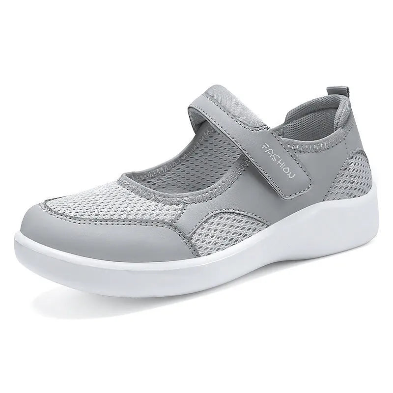 Women's low-top casual shoe in grey mesh with Velcro strap and flat polyurethane sole.