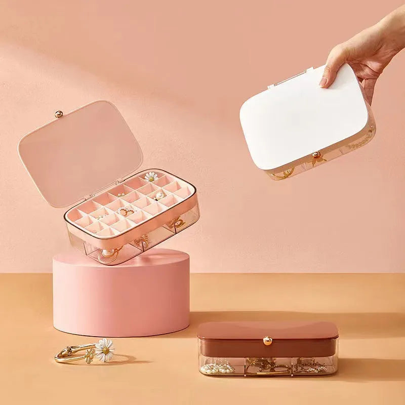 Green minimalist jewellery storage box with multiple internal compartments for rings and earrings.