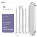 Four silver metal acne needles with fine pointed tips laid out on a flat surface.