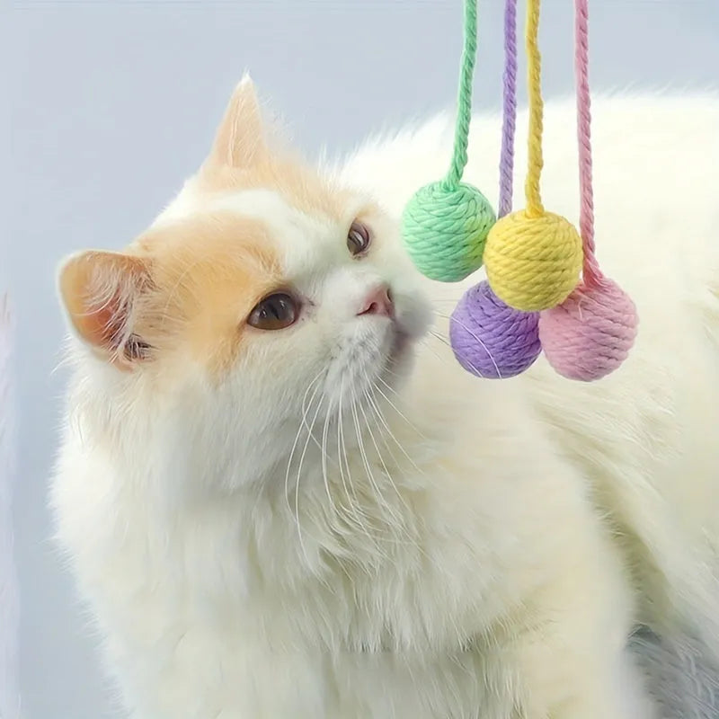 Interactive cat toy ball with rope and internal bell in green, pink, purple and yellow colours