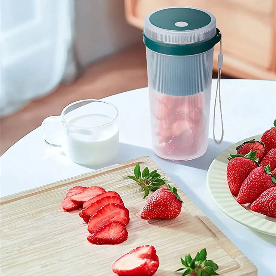 Portable electric blender cup in blue, green, or pink with USB charging cable.