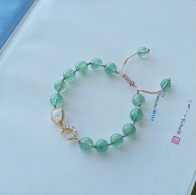 Hetian jade and strawberry quartz crystal bracelet for women showing manual craftsmanship and natural stone variations