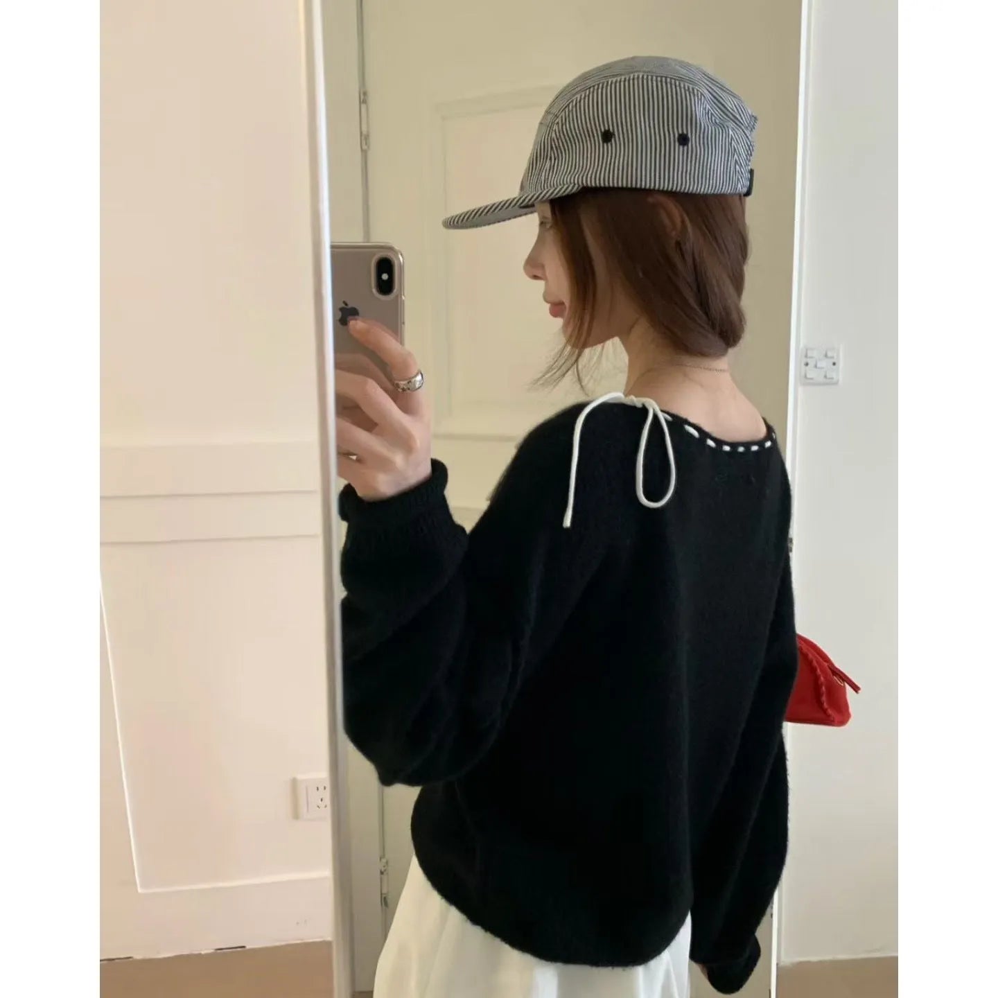 Grey loose-fitting women's long sleeve pullover sweater on a hanger