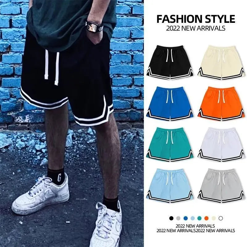 Man wearing loose fit grey polyester sports shorts on a summer day.