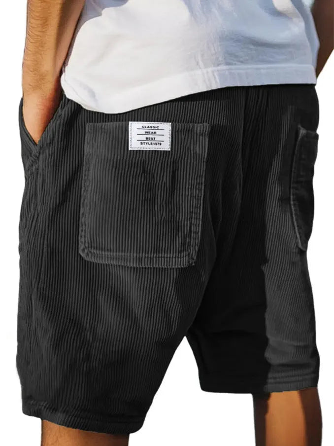 Men's grey straight-fit corduroy shorts with multiple pockets and a small embroidered logo on the leg.