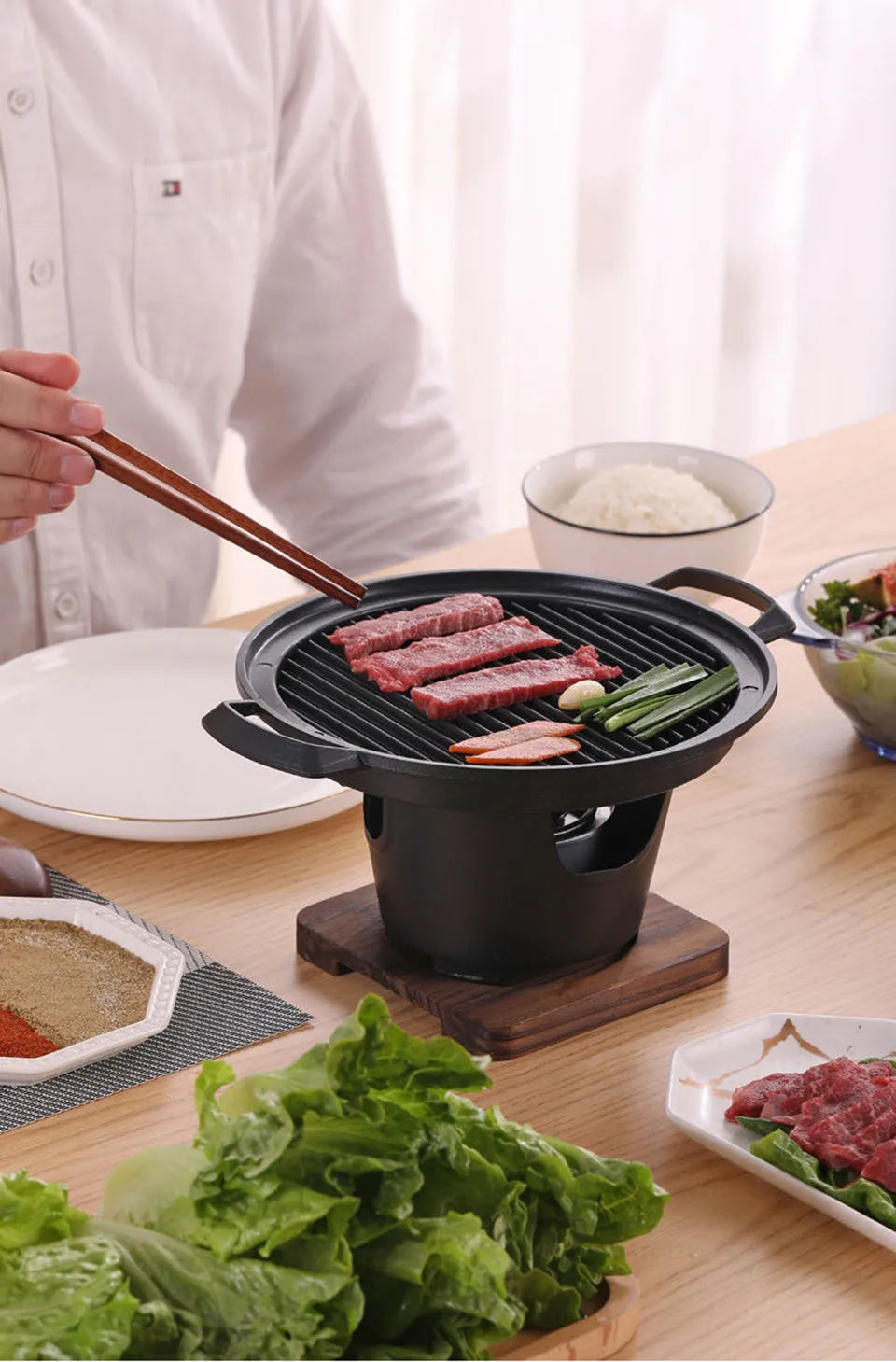 Mini BBQ grill alcohol stove with double-head flame and non-stick plate on tabletop