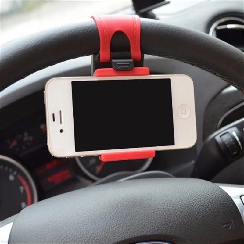 Black universal steering wheel phone holder clip mounted on a car steering wheel with a smartphone secured.