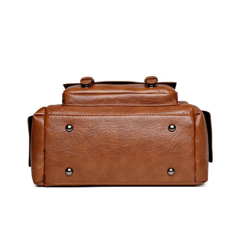 Vintage-style large square messenger bag in PU leather with contrast stitching.
