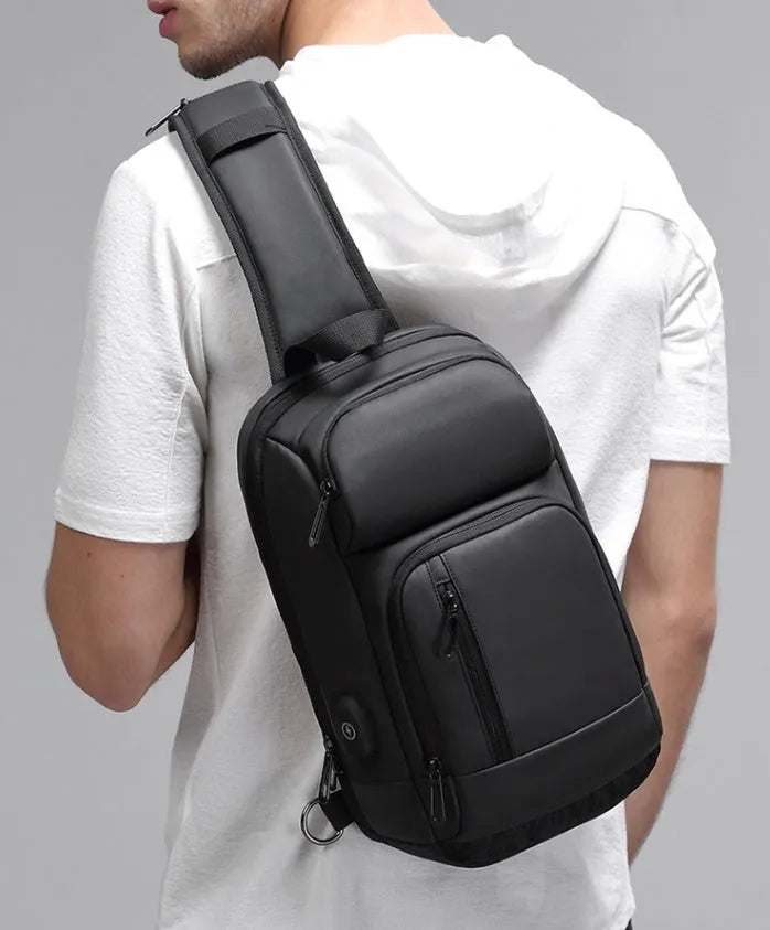 Black PVC outdoor leisure shoulder bag showing air cushion strap and organisational pockets
