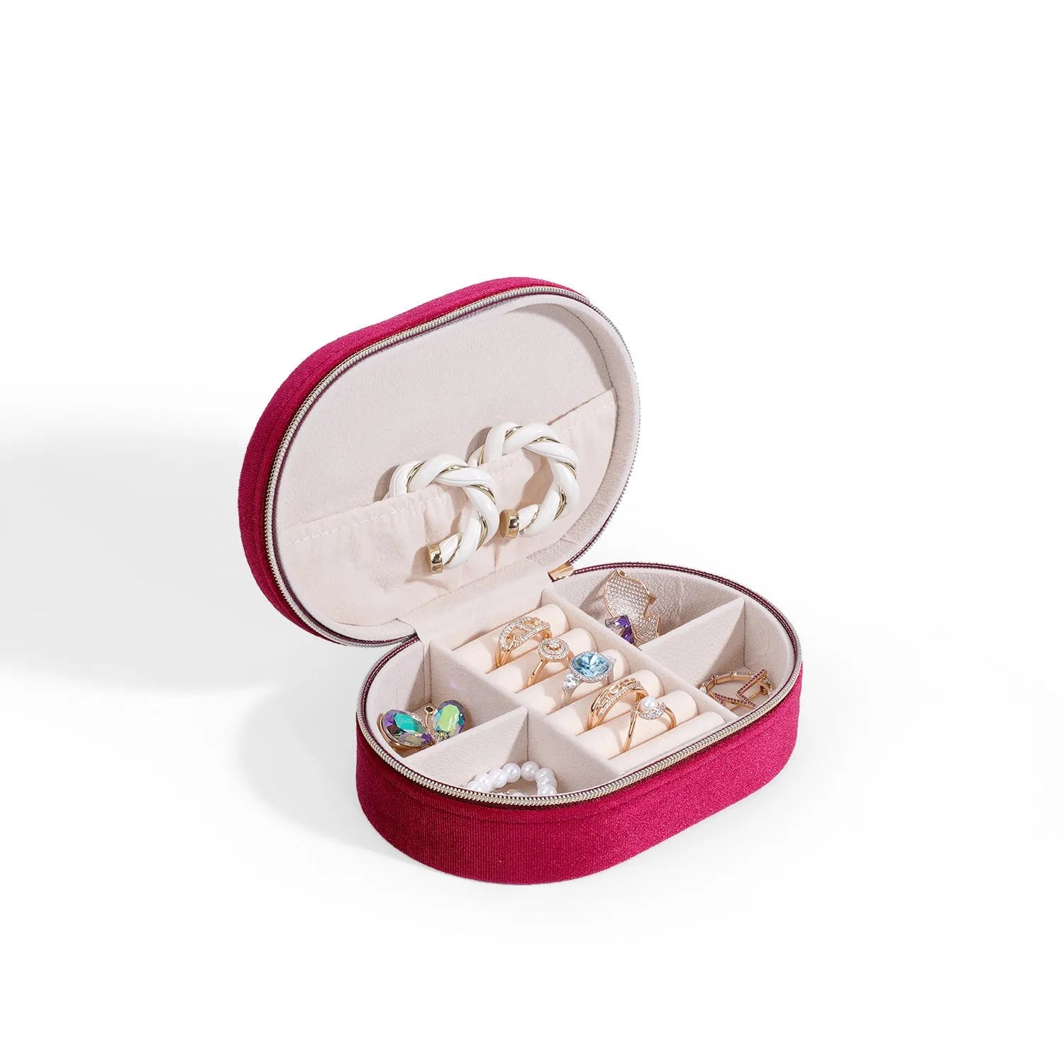 Oval shaped velvet jewellery storage box in multiple colours with flannel interior, measuring 15 by 10 by 5 cm.