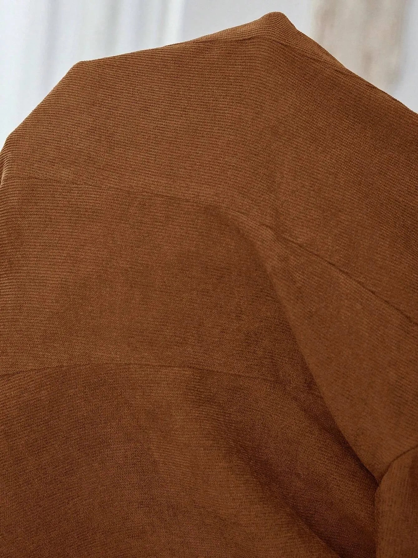 Brown single-breasted lapel leisure coat with long sleeves and four-button front closure