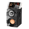 Black portable mini home audio system with subwoofer showing 3.5mm audio cable and USB power connection