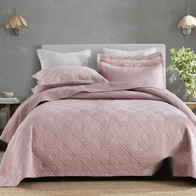 Pure cotton double-sided bed cover three-piece set in a plain colour laid on a bed.