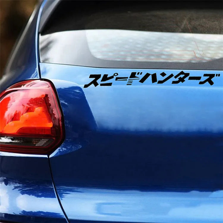 Black and white reflective Japanese car sticker measuring 35x35cm on a vehicle window.