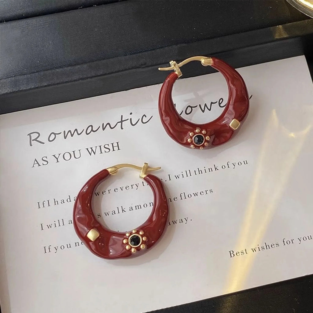Black and red alloy ear studs with rhinestone inlays and dripping oil textured surface